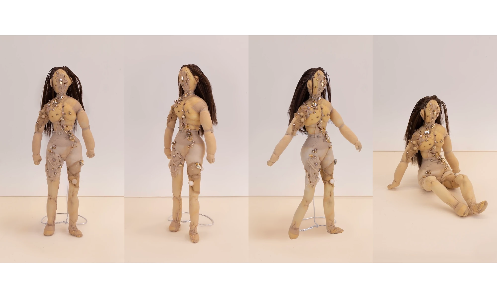 A small stitched doll with long hair in four poses