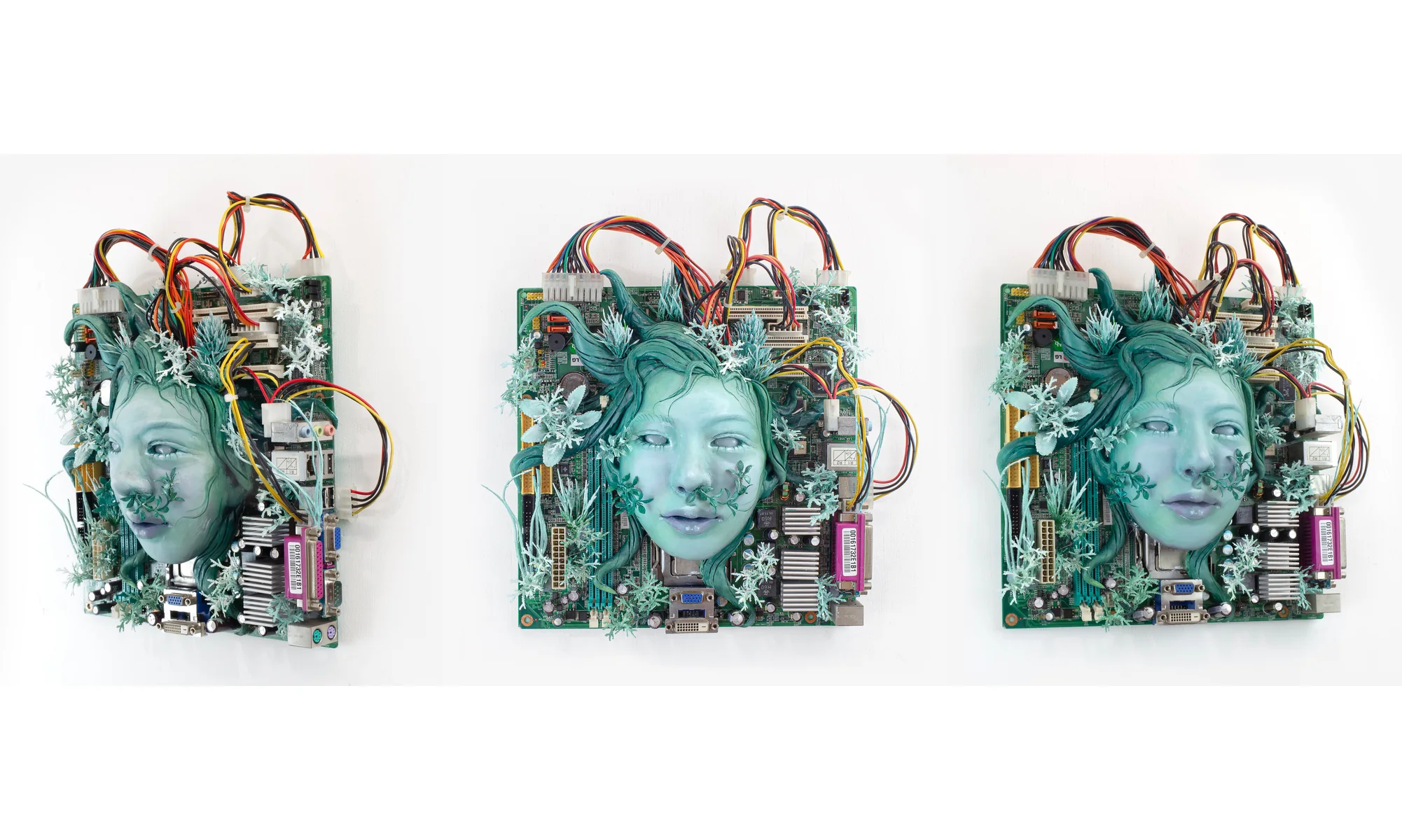 A green clay face set into a computer mainboard with wires, seen from three angles
