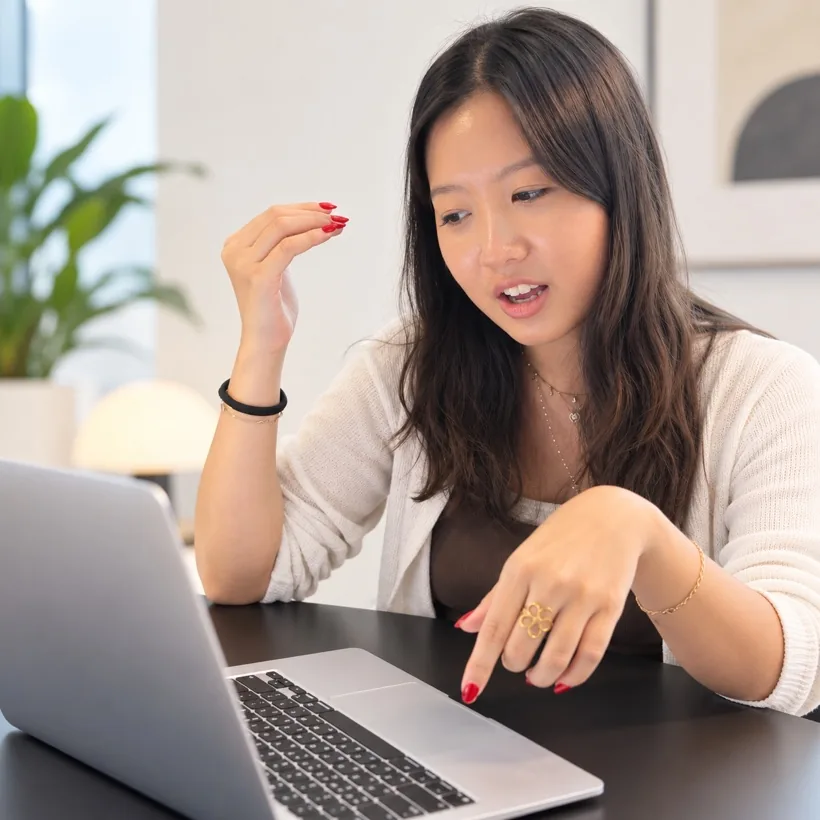 A designer giving feedback in front of a laptop