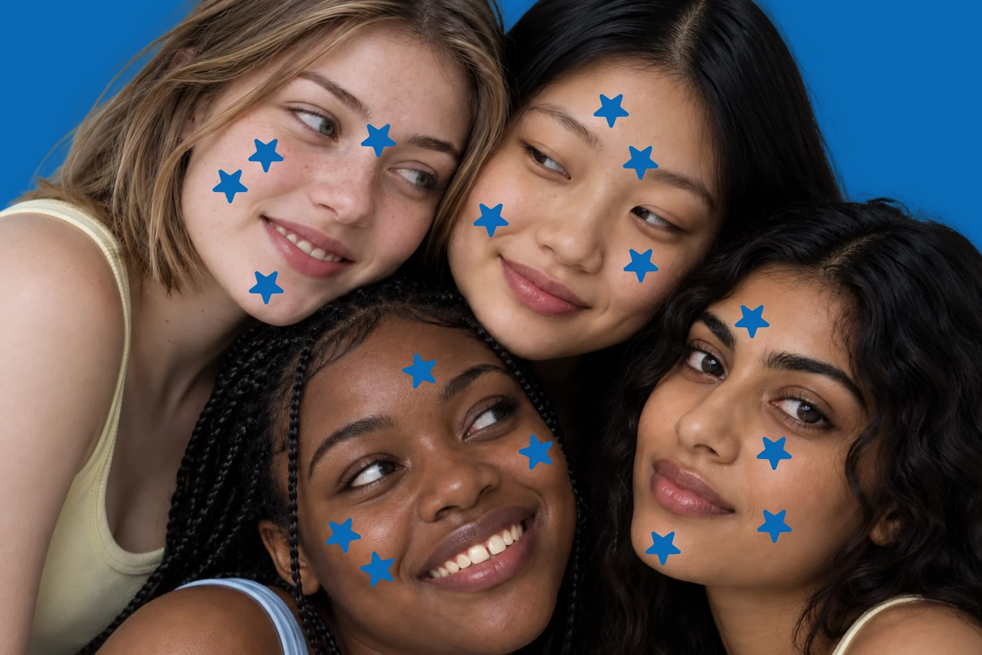 Four young women with different skin tones smiling together, star-shaped cutouts on their faces