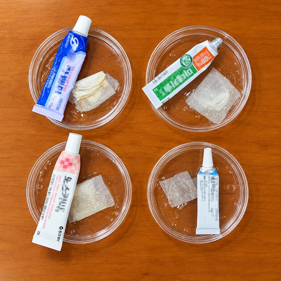 Patch samples in petri dishes next to ointment tubes